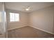 A simple bedroom has neutral walls, newer carpet and a ceiling fan at 12173 W 68Th Ave, Arvada, CO 80004
