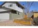 Features a brick exterior, garage, and raised garden beds at 12173 W 68Th Ave, Arvada, CO 80004