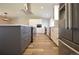 A modern kitchen featuring sleek gray island and white cabinets, stainless steel appliances at 12173 W 68Th Ave, Arvada, CO 80004