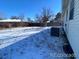 Large backyard with patchy grass and some snow at 5554 Crystal Way, Denver, CO 80239