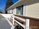 Side view of the home with a small fence and snow on the ground at 5554 Crystal Way, Denver, CO 80239