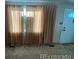 Living room showcasing large windows and light-colored curtains at 5554 Crystal Way, Denver, CO 80239