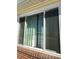 Close-up of sliding window with light green curtains at 5554 Crystal Way, Denver, CO 80239