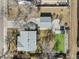 Aerial view of a property showcasing the home, detached garage, spacious yard, and surrounding neighborhood at 4546 S Logan St, Englewood, CO 80113