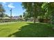 Large grassy backyard enclosed by fences with mature trees providing ample shade at 4546 S Logan St, Englewood, CO 80113
