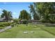 Backyard featuring lush green grass, chain link fence, and established trees at 4546 S Logan St, Englewood, CO 80113