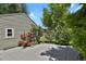 Backyard features a concrete patio, vibrant red roses, and mature trees at 4546 S Logan St, Englewood, CO 80113