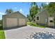 View of detached garage and home exterior showcasing a well-maintained backyard and privacy fence at 4546 S Logan St, Englewood, CO 80113