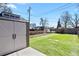 Backyard featuring artificial turf, a storage shed with double doors, and partial fencing at 4546 S Logan St, Englewood, CO 80113