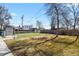 Fenced backyard features a small patch of green grass, shed, and sparse landscaping under a sunny sky at 4546 S Logan St, Englewood, CO 80113