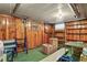 The unfinished basement features wood paneling, a small window for natural light, and exposed piping for a rustic feel at 4546 S Logan St, Englewood, CO 80113