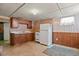 Basement kitchen with updated appliances, cabinets and counters, window, and plenty of open space at 4546 S Logan St, Englewood, CO 80113
