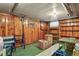 Basement featuring wood paneling, shelving, and boxes for storage or organization at 4546 S Logan St, Englewood, CO 80113