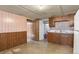 Finished basement featuring a functional kitchenette with wood cabinets, unique wallpaper, and plenty of potential at 4546 S Logan St, Englewood, CO 80113