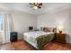Bedroom featuring hardwood floors, a ceiling fan, bright windows and a comfortable bed at 4546 S Logan St, Englewood, CO 80113