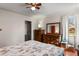 Comfortable bedroom with hardwood floors, bright windows, dresser, and a walk-in closet at 4546 S Logan St, Englewood, CO 80113