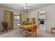 Inviting dining space with a large window, featuring carpet and open access to the kitchen at 4546 S Logan St, Englewood, CO 80113