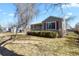 Attractive home featuring a lush lawn and mature trees, providing a serene and welcoming atmosphere at 4546 S Logan St, Englewood, CO 80113