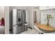 Modern kitchen with stainless steel refrigerator, marble floors, and eat-in dining area at 4546 S Logan St, Englewood, CO 80113