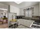 Bright kitchen featuring white cabinets, black countertops, and a cozy breakfast nook area at 4546 S Logan St, Englewood, CO 80113
