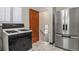 Modern kitchen with stainless steel refrigerator, marble floors, gas range and convenient layout at 4546 S Logan St, Englewood, CO 80113