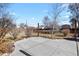Backyard featuring a concrete patio area, limited landscaping, and partial fencing under a sunny sky at 4546 S Logan St, Englewood, CO 80113