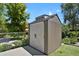 Backyard storage shed with double doors, vertical siding, and a concrete pad at 4546 S Logan St, Englewood, CO 80113