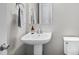 Small bathroom with pedestal sink and toilet at 5524 Uinta St, Denver, CO 80238