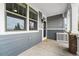 Inviting front porch with gray siding and brick accents at 5524 Uinta St, Denver, CO 80238