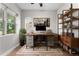 Bright home office with built-in shelving and large windows at 5524 Uinta St, Denver, CO 80238