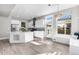 Modern kitchen with white cabinets, island, and eat-in area at 5524 Uinta St, Denver, CO 80238