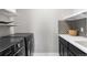 Modern laundry room with washer, dryer, and custom shelving at 5524 Uinta St, Denver, CO 80238