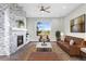 Living room with stone fireplace and large windows at 5524 Uinta St, Denver, CO 80238