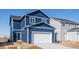 Two-story home with blue siding and white garage door at 693 N Tempe St, Aurora, CO 80018