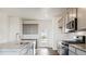 Modern kitchen with gray cabinets, granite counters and island at 693 N Tempe St, Aurora, CO 80018