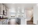 Modern kitchen with gray cabinets, granite counters and island at 693 N Tempe St, Aurora, CO 80018