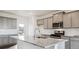 Modern kitchen with gray cabinets, granite counters and island at 693 N Tempe St, Aurora, CO 80018