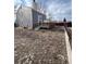 A serene backyard featuring a well-maintained deck, offering a private outdoor space, surrounded by a leafy ground cover at 11449 E 1St Ave, Aurora, CO 80010