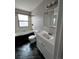 Bathroom with a tub-shower, large mirror, vanity and dark tile flooring at 11449 E 1St Ave, Aurora, CO 80010