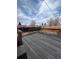 A weathered wooden deck with wood railing, perfect for enjoying the backyard scenery and outdoor living at 11449 E 1St Ave, Aurora, CO 80010