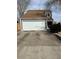 Charming home with two-car garage, gray siding, brown roof, and a large concrete driveway at 11449 E 1St Ave, Aurora, CO 80010