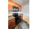 Kitchen with granite countertops, black appliances, and wooden cabinetry at 11449 E 1St Ave, Aurora, CO 80010