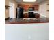 Kitchen with dark granite countertops, black appliances, and wooden cabinetry at 11449 E 1St Ave, Aurora, CO 80010