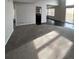An expansive living room, offering comfort and style with a neutral color palette, large windows, and deck access at 11449 E 1St Ave, Aurora, CO 80010