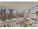 Balcony overlooking neighborhood with trees at 8555 Fairmount Dr # G208, Denver, CO 80247