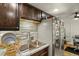 Well-lit kitchen with stainless steel sink, modern faucet, and tile backsplash at 8555 Fairmount Dr # G208, Denver, CO 80247