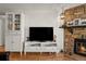Cozy living room features a stone fireplace, wood floors, and built-in shelving at 8555 Fairmount Dr # G208, Denver, CO 80247