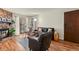 Inviting living room with hardwood floors, stone fireplace, and sliding glass doors at 8555 Fairmount Dr # G208, Denver, CO 80247