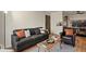 Comfortable living room featuring a sofa, stylish decor, and wood flooring at 8555 Fairmount Dr # G208, Denver, CO 80247