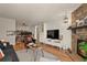 Spacious living room with hardwood floors, stone fireplace, and built-in shelving at 8555 Fairmount Dr # G208, Denver, CO 80247